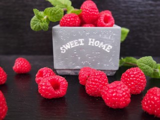 Raspberries with mint on black background © Agnieszka