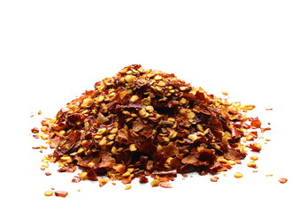 pile crushed red pepper, dried chili flakes and seeds isolated on white background