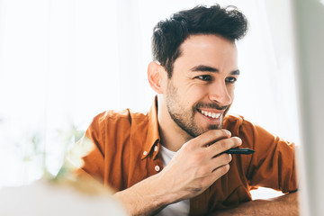 Close up shot of happy businessman with cheerful smile achieving life goals. Success and...