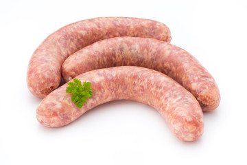 Raw sausage with parsley leaf isolated on white background.