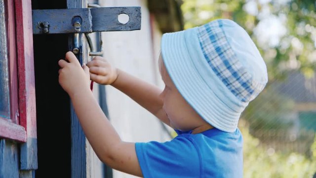 A funny country girl plays with an old lock in the barn for 2-3 years. Lovely home video with a child