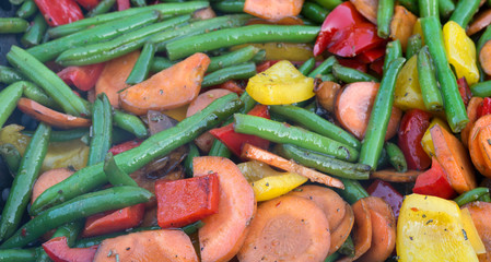 Grilled vegetables - green beans, red and yellow bell peppers and carrot. Selective focus..