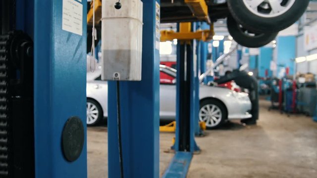 Mechanic works in the automotive service, slider