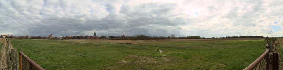 Obraz premium Meadows an city skyline near Greifswald in Mecklenburg-Vorpommern in Germany