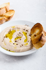 White bean dip on white plate