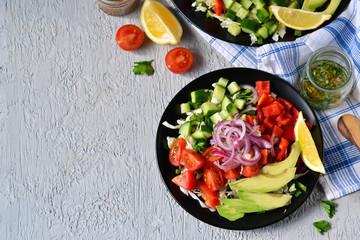 Vegetable salad with avocado and mustard sauce on a concrete, gray background