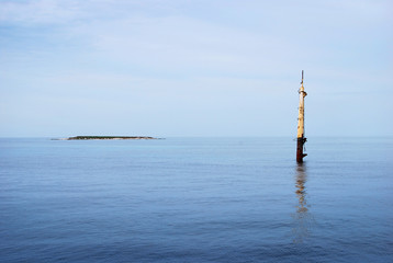 Sunken vessel in adriatic sea with small coral reef  in background. Shot while sailing in Croatia.