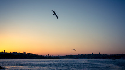 Fototapeta na wymiar Istanbul, Turkey - April 10 2015: Sunset over Bosphorus in Istanbul cityscape