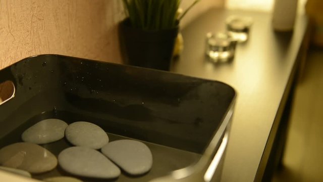 Massage stones are heated in a hot water bath