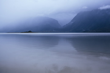 Calm Water on Rainy Day in Alaska with Misty Mountains