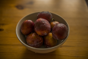 Ripe plums on wood table
