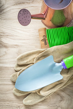 Hand spade gardening gloves watering can garden soft tie on wood