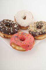 donuts on a plate on a white background