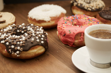 Obraz na płótnie Canvas donuts and coffee on a wooden table