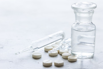 meds and vials on doctors workplace on white background