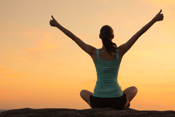 Healthy woman celebrating during a beautiful sunset. Happy and Free.
