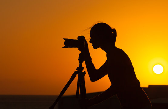 Silhouette of photographer taking pictures of nature. 