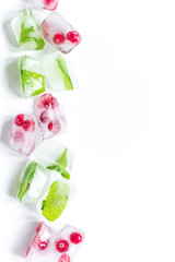 Ice cubes with berries and mint white background top view mock up