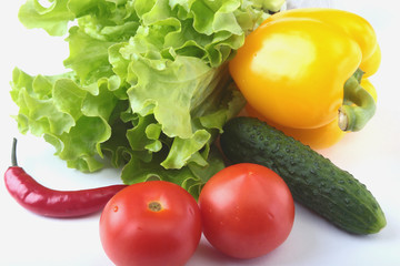 Assorted vegetables, fresh bell pepper, tomato, chilli pepper, cucumber and lettuce isolated on white background. Selective focus.