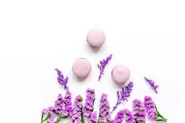Trendy woman pattern with flowers and macaroons on plate top view mockup