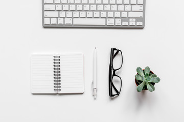 Modern office table with keyboard, glasses, notebook on white background top view mock-up