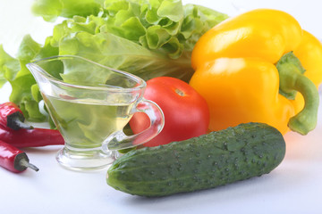 Assorted vegetables, fresh bell pepper, tomato, chilli pepper, cucumber, olive oil and lettuce isolated on white background. Selective focus.