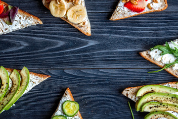lunch with triangle sandwiches on dark table background top view mockup