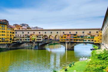 Obraz premium Ponte Vecchio, Old Bridge, medieval stone arch bridge over the Arno River and with many small shops along it, Florence, Tuscany, Italy, Europe. UNESCO World Heritage Site