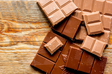 black and milk chocolate bars dark wooden table background top view mockup
