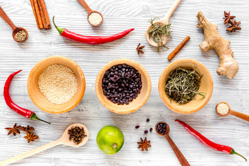Dry colorful spices, chili pepper on kitchen light table background top view