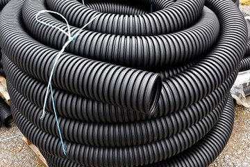 Coiled and stacked drainage tubing.