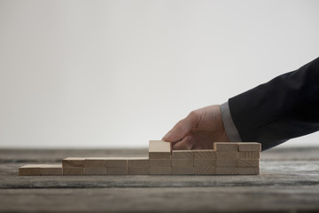 Close-up view of male hand building little staircase