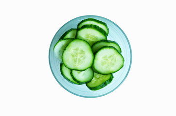 Bowl of fresh cucumber slices on white background.