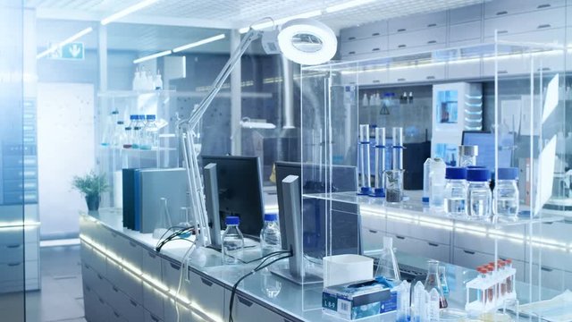 Bright and Ultra Modern High Tech Laboratory Full of Advanced Technological Wonders, Computers, Analyzing Machines, Test Tubes and Beakers. Shot on RED EPIC-W 8K Helium Cinema Camera.