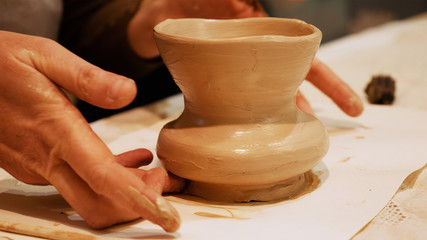 Potter is making clay pot bowl or vase ceramics porcelain on the potter's wheel. Creating pottery...