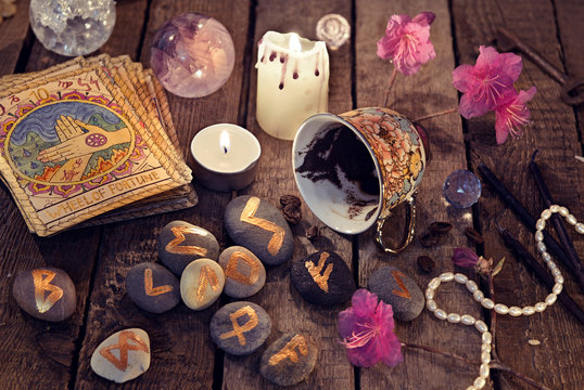 Divination rite with coffee grounds, tarot cards and stone runes reading