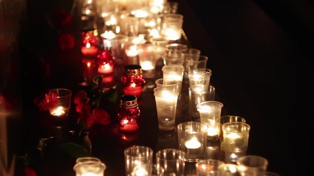 Memorial in memory of those killed by the terrorist attack. People brought many flowers and candles. Grief and compassion of people. Consequences of the terrorist attack, military actions, politics.