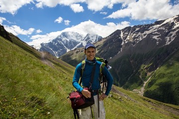 Fototapeta na wymiar A man makes selfie against the background of a mountain in the region of Elbrus