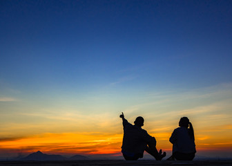 Silhouette of couple love outside sunset