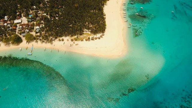Aerial view of beautiful tropical island Daco with white sand beach. View of a nice tropical beach from the air. Beautiful sea, resort. Seascape: Ocean and beautiful beach paradise. Philippines. 4K