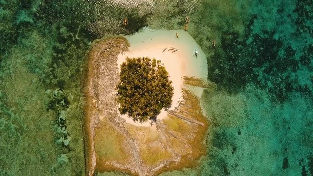 Aerial view of beautiful tropical island Guyam with white sand beach. View of a nice tropical beach from the air. Seascape: Ocean and beautiful beach paradise. Philippines. 4K video. Travel concept