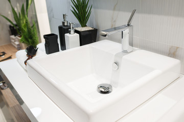 Modern faucet with white washbasin bathroom interior
