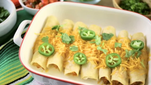 Chicken enchiladas with cheddar cheese and sauce