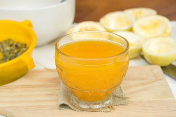 passion fruit and Juice in glass on wood table