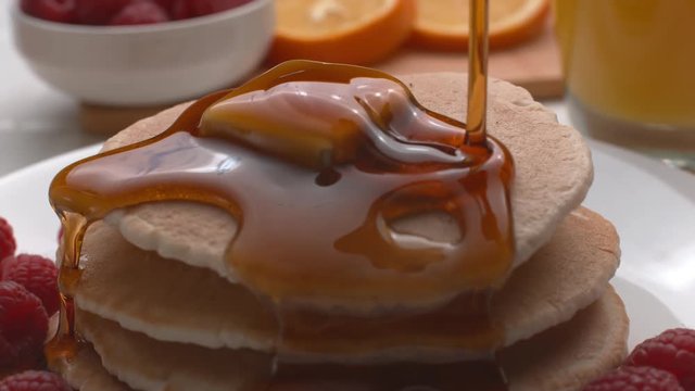 Syrup pouring onto stack of pancakes in super slow motion, shot on Phantom Flex 