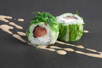 rolls with tuna in green seawed with nut sauce