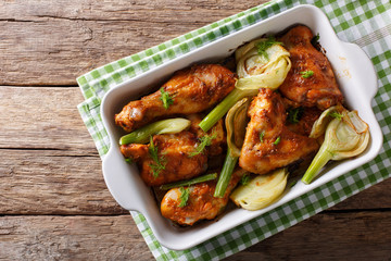 Delicious chicken baked with fennel bulbs in a baking dish close-up. horizontal top view