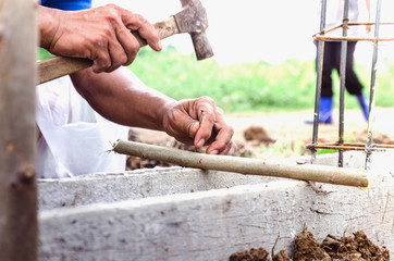 Carpenters use nail hammers in construction site