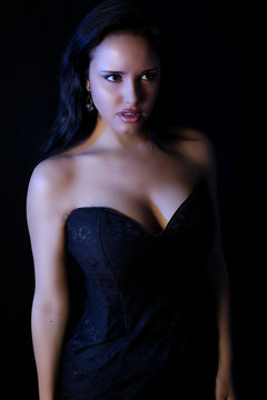 Beautiful vampire woman wearing a black dress