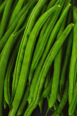 string beans on dark stone background